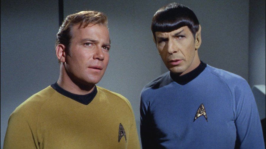 Kirk and Spock gazing off at something with curiosity and concern.