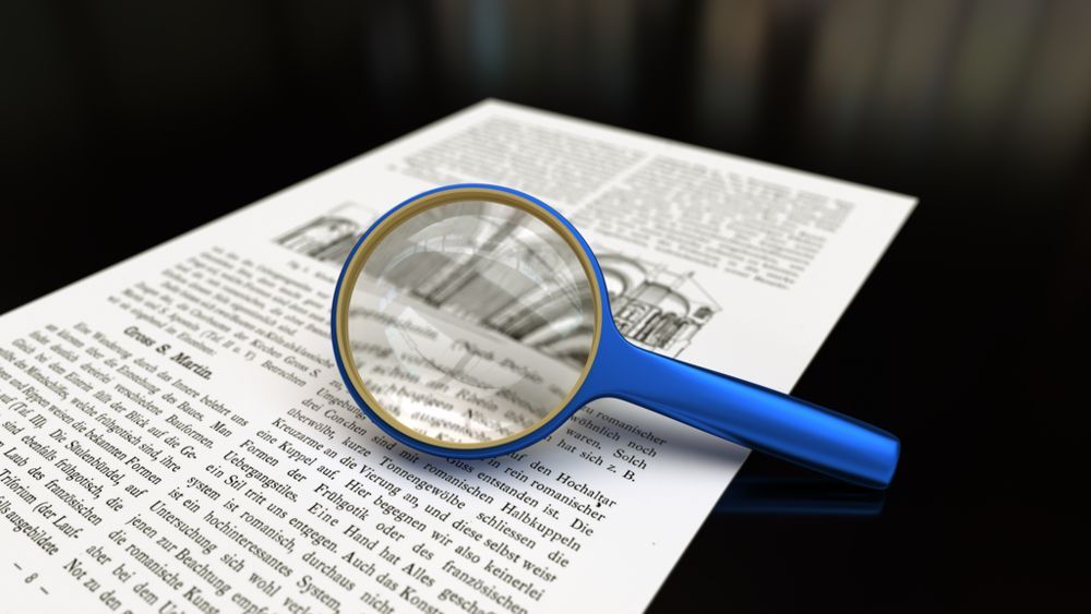 magnifying glass over a sheet of printed paper