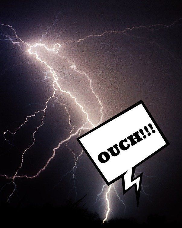 lightning in the night sky with the words OUCH!!